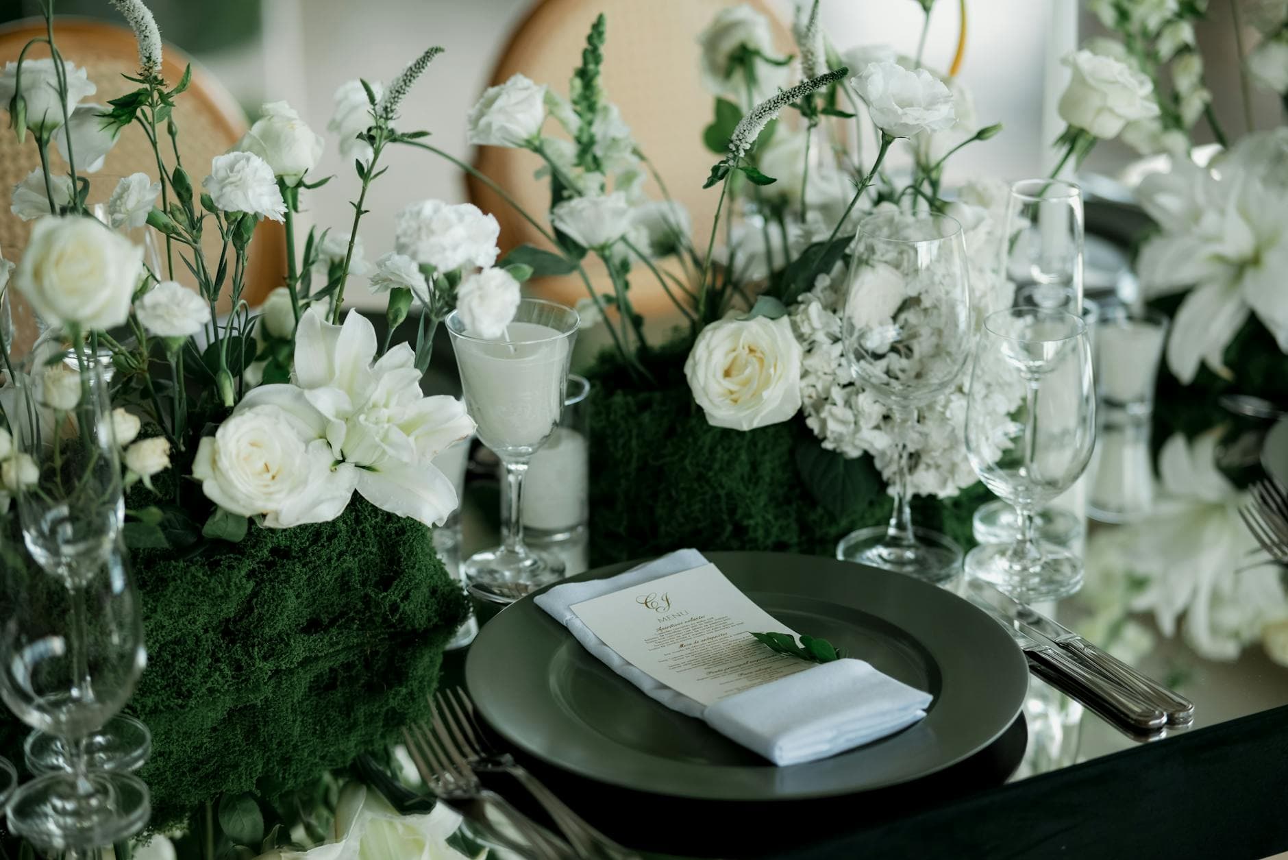 Bridal shower table with white roses, glassware, and menu card