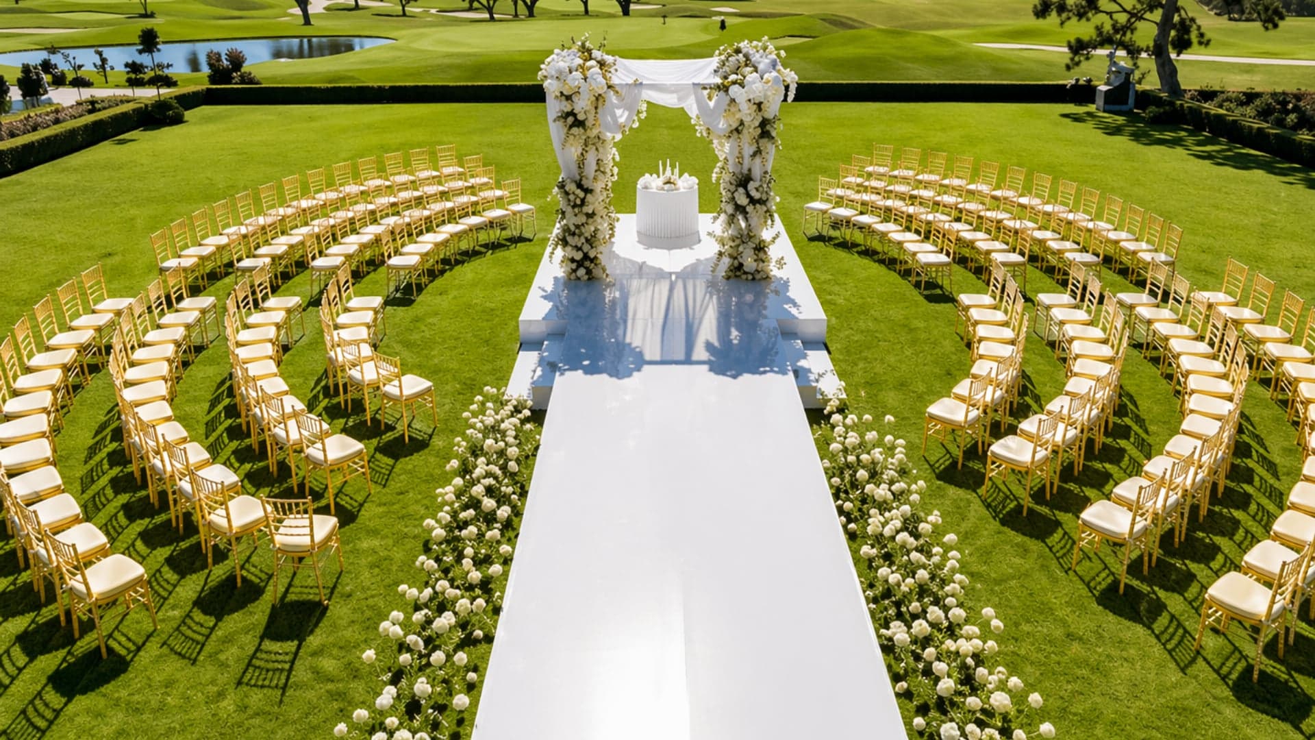 Outdoor wedding ceremony with circular gold chiavari seating and floral arch