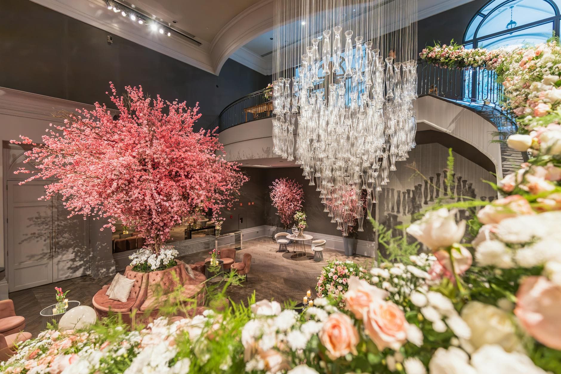 Lush floral installation with crystal chandelier in a luxe venue