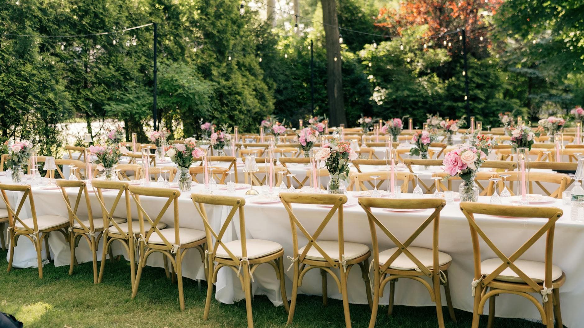 Outdoor garden banquet with crossback chairs and pink florals