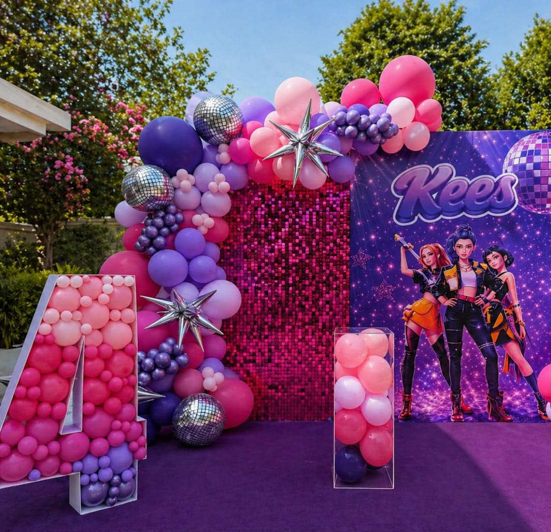 Pink and purple balloon arch with disco balls and Kees backdrop by Four Kees